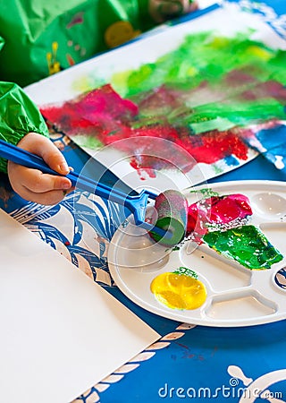 Child painting with roller