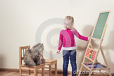 Child playing with cat school.