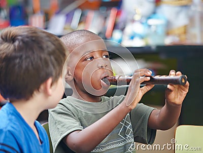 Child playing flute in music school