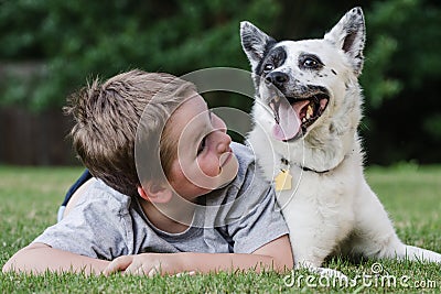 Child playing with his pet dog