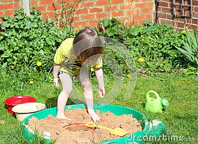 Child playing in a sandpit.