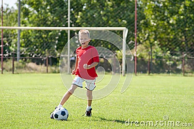 Child playing soccer ball