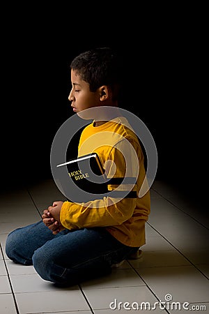 Child Praying with Bible