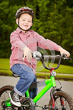 Child riding bike with safety helmet