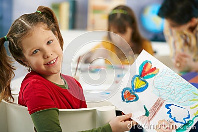 Child showing painting in art class