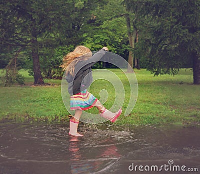 Child Splashing in Dirty Mud Puddle