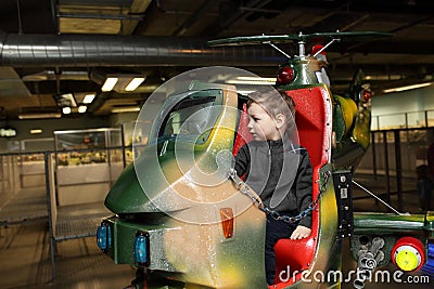 Child on toy helicopter