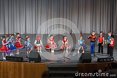 Children in beautiful costume performs on stage