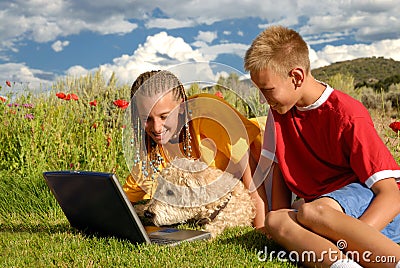 Children with dog at computer