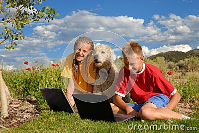 Children with dog and laptop
