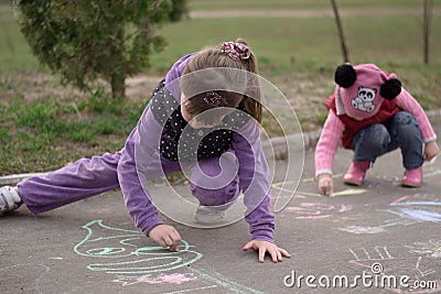 Children draw chalk on the street