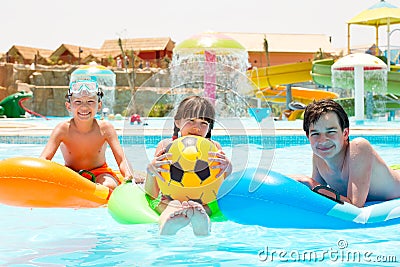 Children floating on pool toys