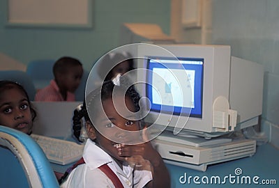 Children in front of vintage Apple computer