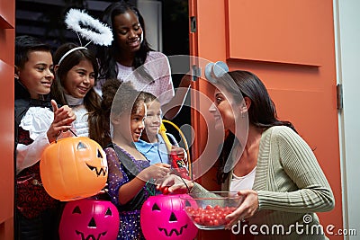 Children Going Trick Or Treating With Mother
