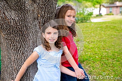 Children group friend girls playing on tree