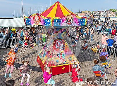 Children have fun in a carousel at a Dutch national holiday