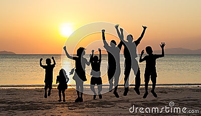 Children jumping at sunset time