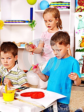 Children painting at easel.