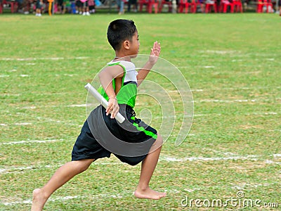 Children and parents doing a teamwork racing at Kindergarten sport day