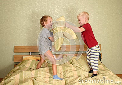 Children play with pillows