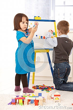 Children playing with drawing board