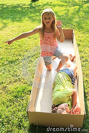 Children playing and sleeping in a box