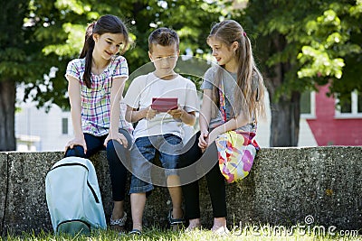 Children playing video games outdoors
