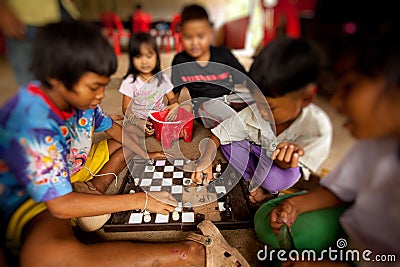 Children from poor areas in play chess