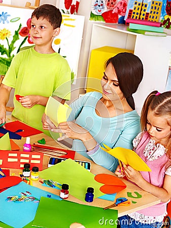 Children with teacher at classroom.