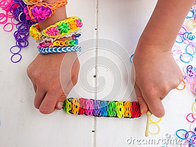 Childs hands showing multicoloured bracelet