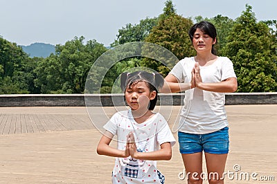 Chinas mother and daughter practice yoga