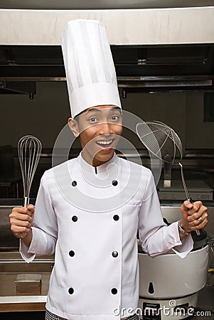 Chinese chef showing utensils