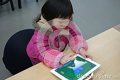 Chinese child playing ipad