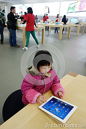 Chinese child playing ipad in the apple store