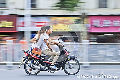 Chinese couple on gas motorcycle