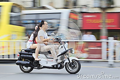 Chinese couple on a motorcycle
