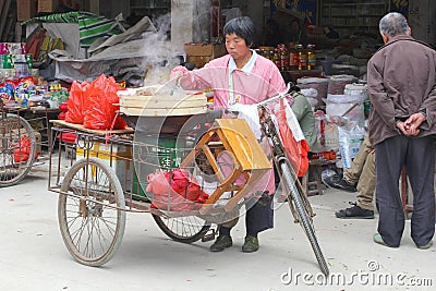 Cooking in the street outdoors,Xingping,China