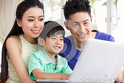 Chinese Family At Desk Using Laptop