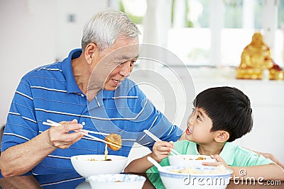 Chinese Grandfather And Grandson Eating Meal