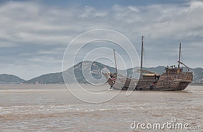 chinese junk boat moving past a small island near Zhoushan on its 