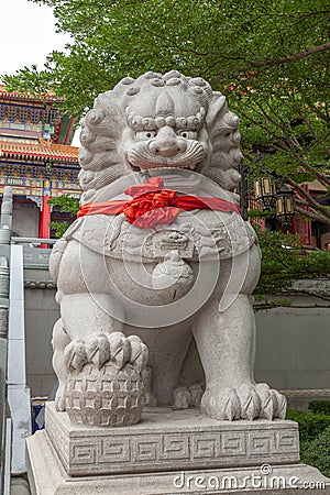 Chinese lion statue with red ribbon
