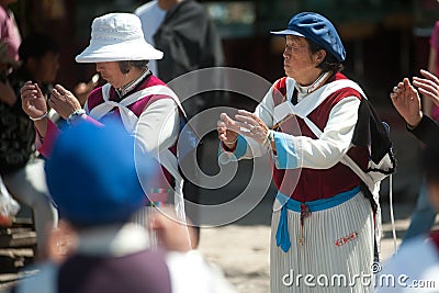 Chinese Naxi old woman performing a dance.