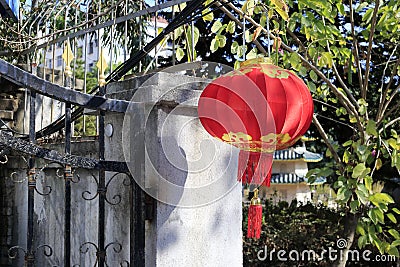 Chinese people hanging red lanterns