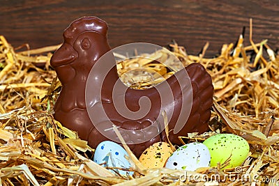 Chocolate hen sitting on easter eggs