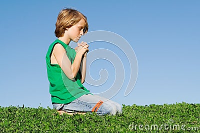 Christian child kneeling praying