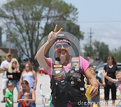 Christian Motorcycle Club lady in parade in small town America