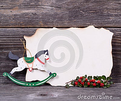 Christmas background with empty paper and wooden horse decoratio