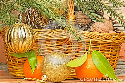 Christmas balls and tangerines on a background of a basket with