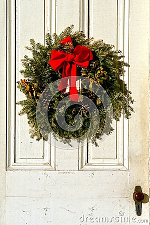 Christmas Pine Wreath with Red Bow on Antique Door