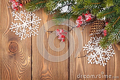 Christmas wooden background with snow fir tree and decor